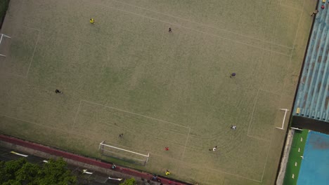 football-team-doing-training-drills,-overhead-aerial