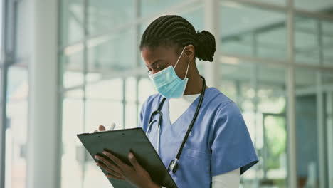 nurse taking notes in hospital