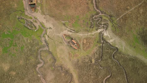 Top-down-spiral-descent-view-of-rusting-shipwreck-at-Fleetwood-Marshes-Nature-Reserve