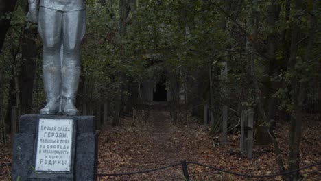 Feet-Of-A-Statue-On-Pedestal-At-The-Entrance-Of-A-Deserted-Kindergarten-In-Chernobyl-Exclusion-Zone---handheld-shot