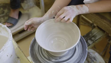 The-hands-of-the-artist-skillfully-mold-the-clay-on-the-spinning-wheel