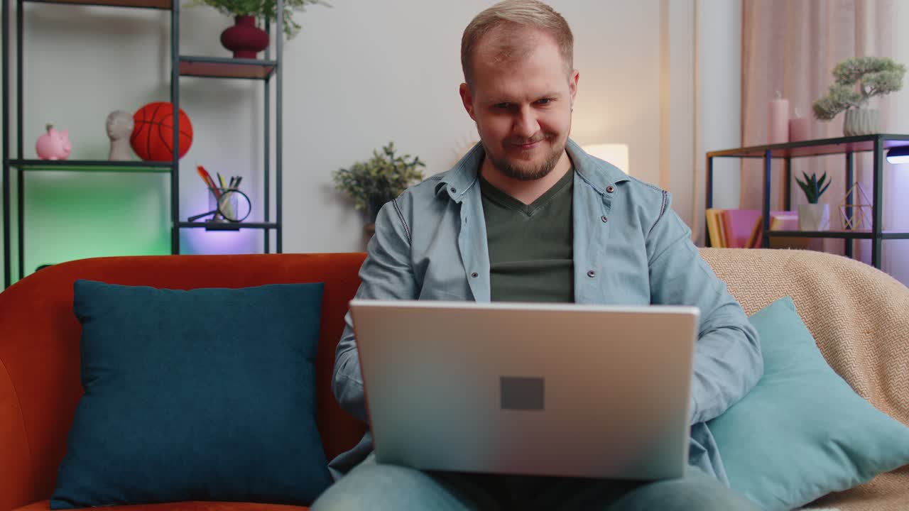 Adult man at home office use laptop pc typing browsing say wow yes found out great big win celebrate