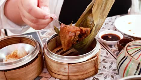 person savoring dim sum at a local eatery