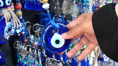 woman selecting turkish evil eye charms