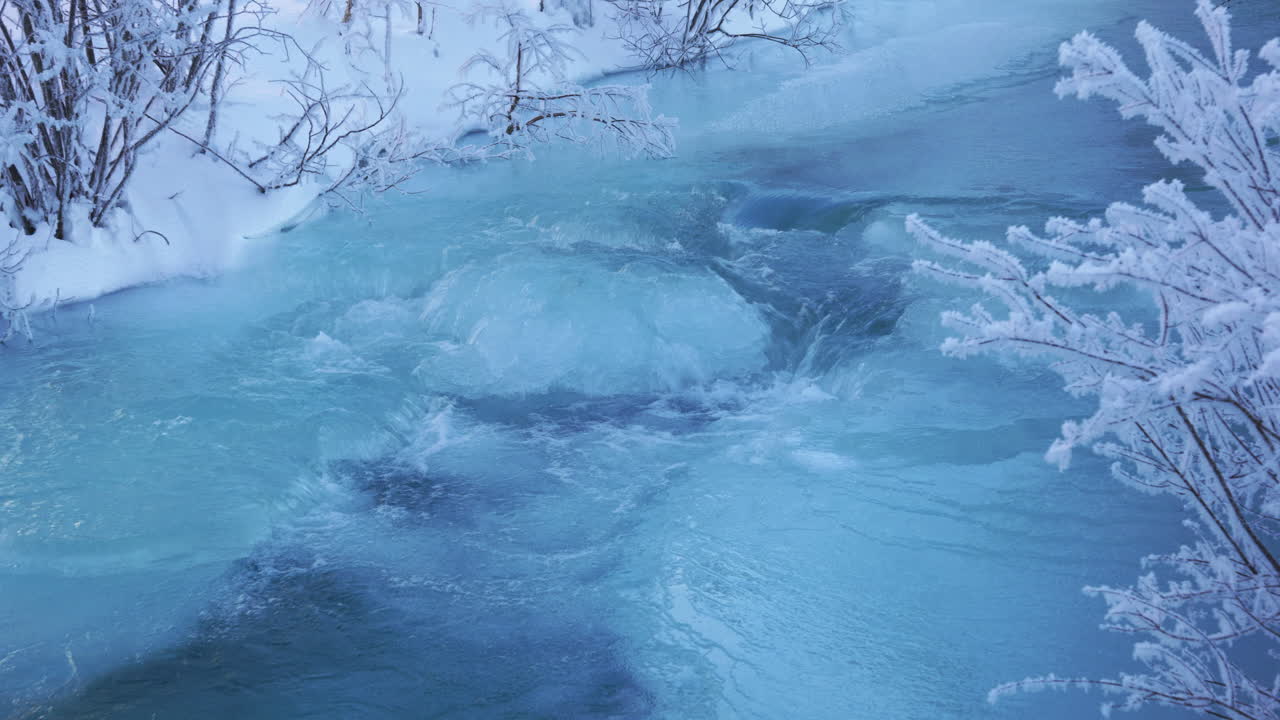 Frozen river with water running over the ice
