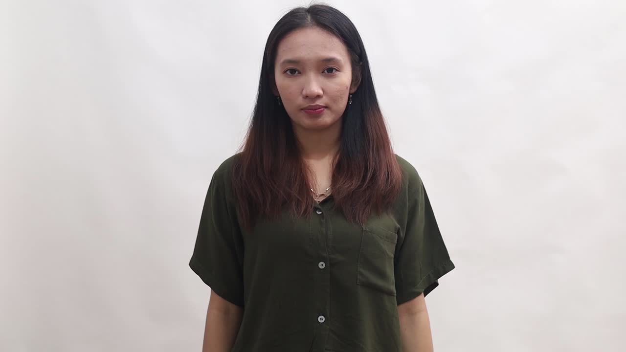 Asian woman with OKAY sign, ok gesture. Happy lady, correct choice, isolated on white background