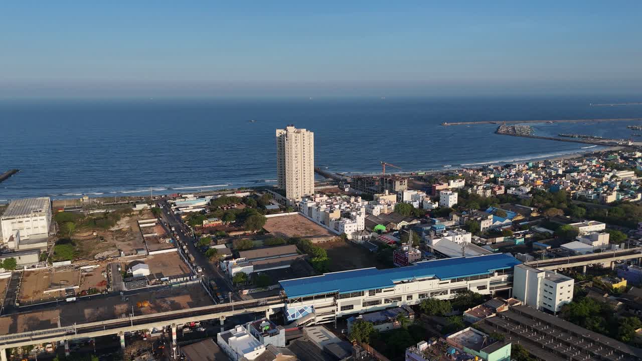High-altitude drone view capturing local trains passing through Chennai suburbs