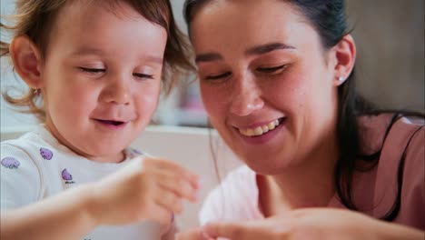 a heartwarming moment of connection between a mother and her young daughter as they share joyful learning together in a creative activity