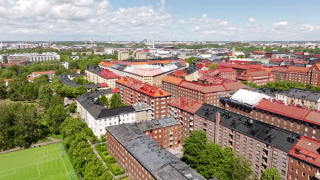 aerial view over a soccer field and buildings in toolo, summer day in finland
