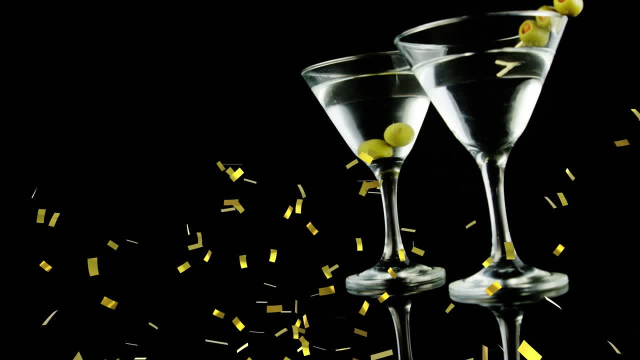 검은 바탕에 와인과 올리브의  ⁇ 테일 컵 위에 떨어지는 콘페티의 애니메이션