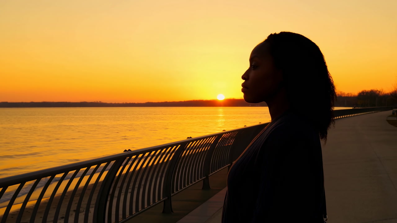 Black Woman Silhouette At Waterfront Sunset, Contemplative Traveler Gazing Over River From Promenade Metal