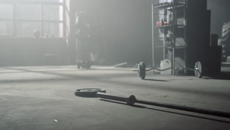 barbell with heavy weights lying on floor. interior of gym with sports equipment