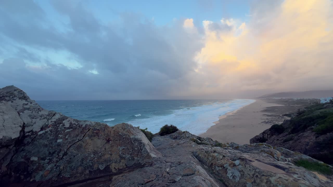 wide shot Serene Sunset Beach with Relaxed Bathers