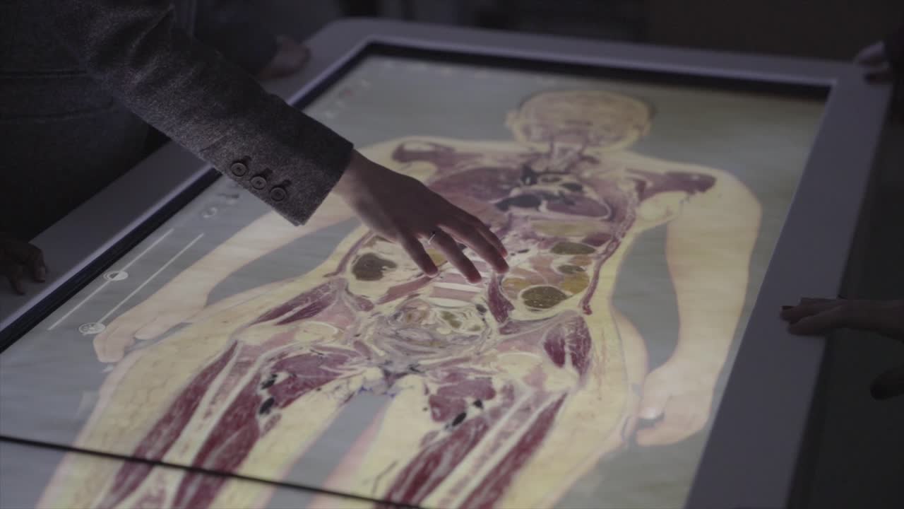 Teacher and students using a medical touchpad