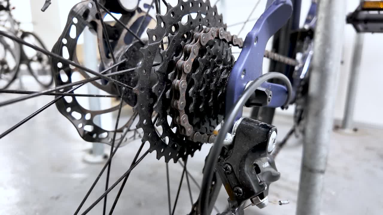 Focus on the mechanics of a bicycle's transmission, highlighting the cassette and derailleur