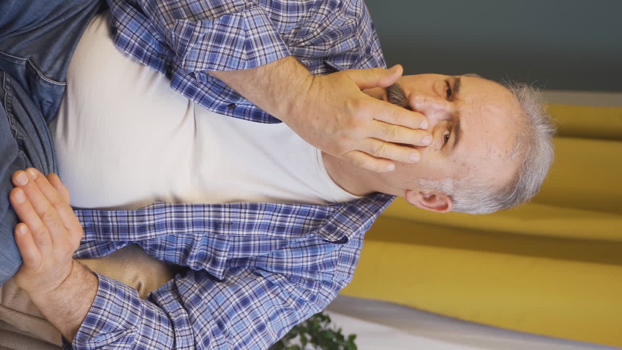 Vertical video of Old man with wrinkles and problems on his skin is unhappy.