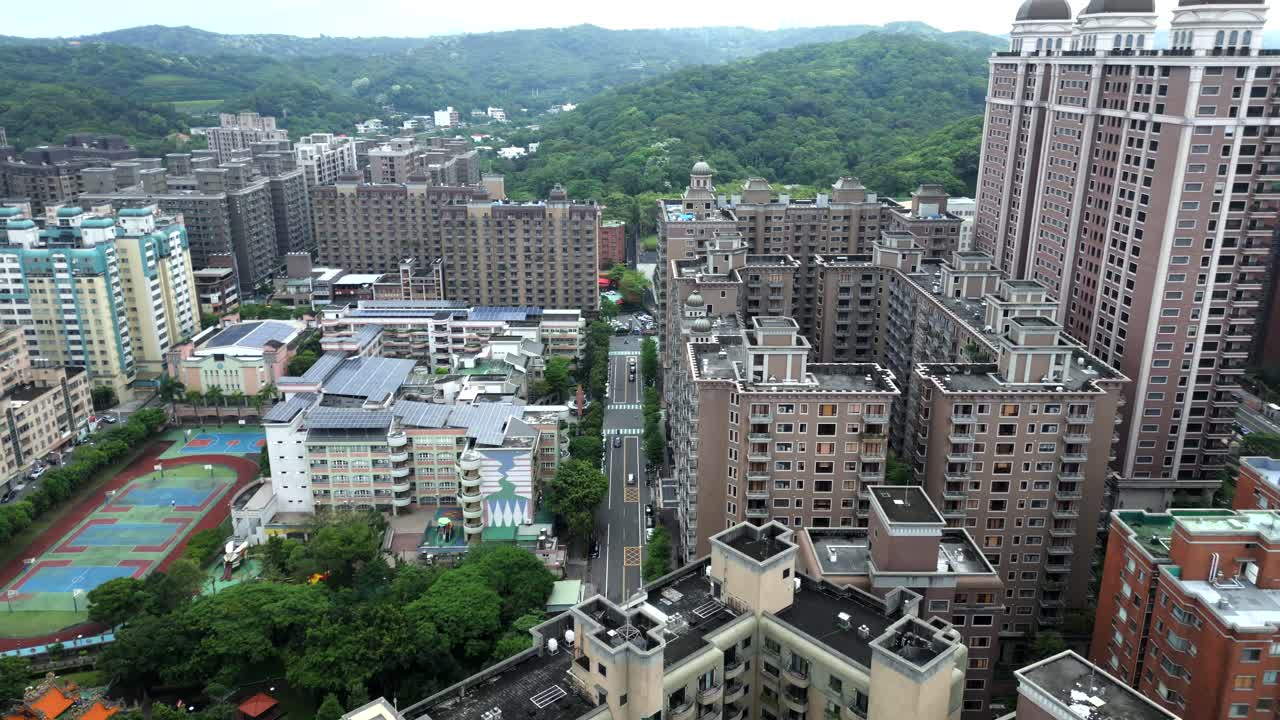 Apartment Complex With Dagu Mountains In The Background At Luzhu District In Taoyuan City, Taiwan. Aerial Drone Shot