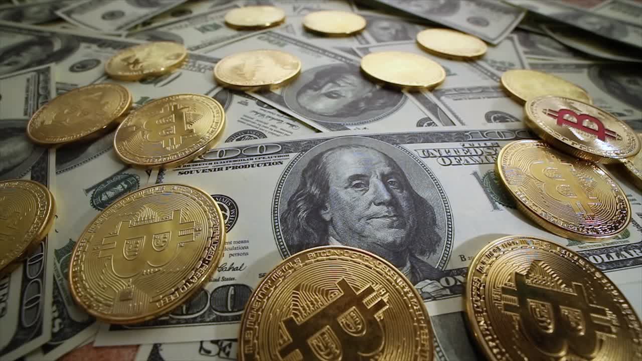 Gold Bit Coin BTC coins and dollar bills.