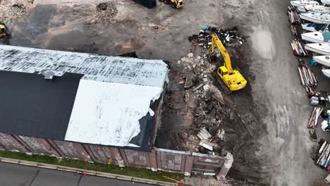 tilting up from direct aerial of the rubble to the lake