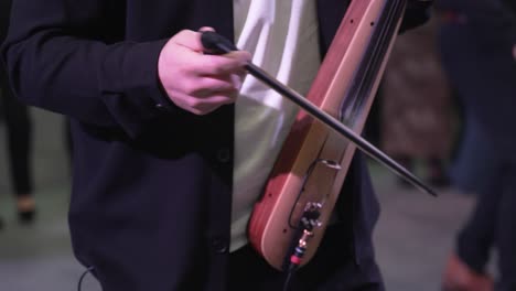 musical performance in a lively atmosphere showcasing a unique string instrument played with a bow