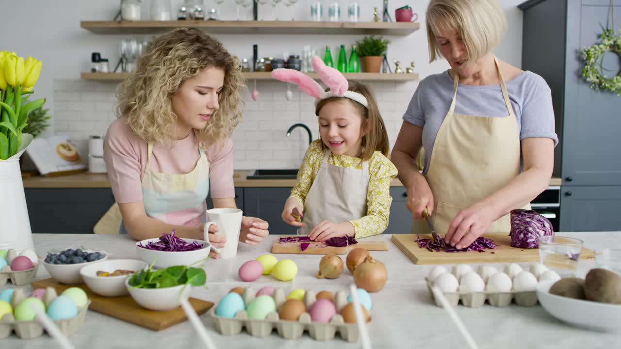 Tilt up video of family preparing natural dyes to color eggs