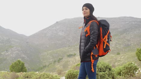 Happy-smiling-woman-enjoying-a-misty-hike