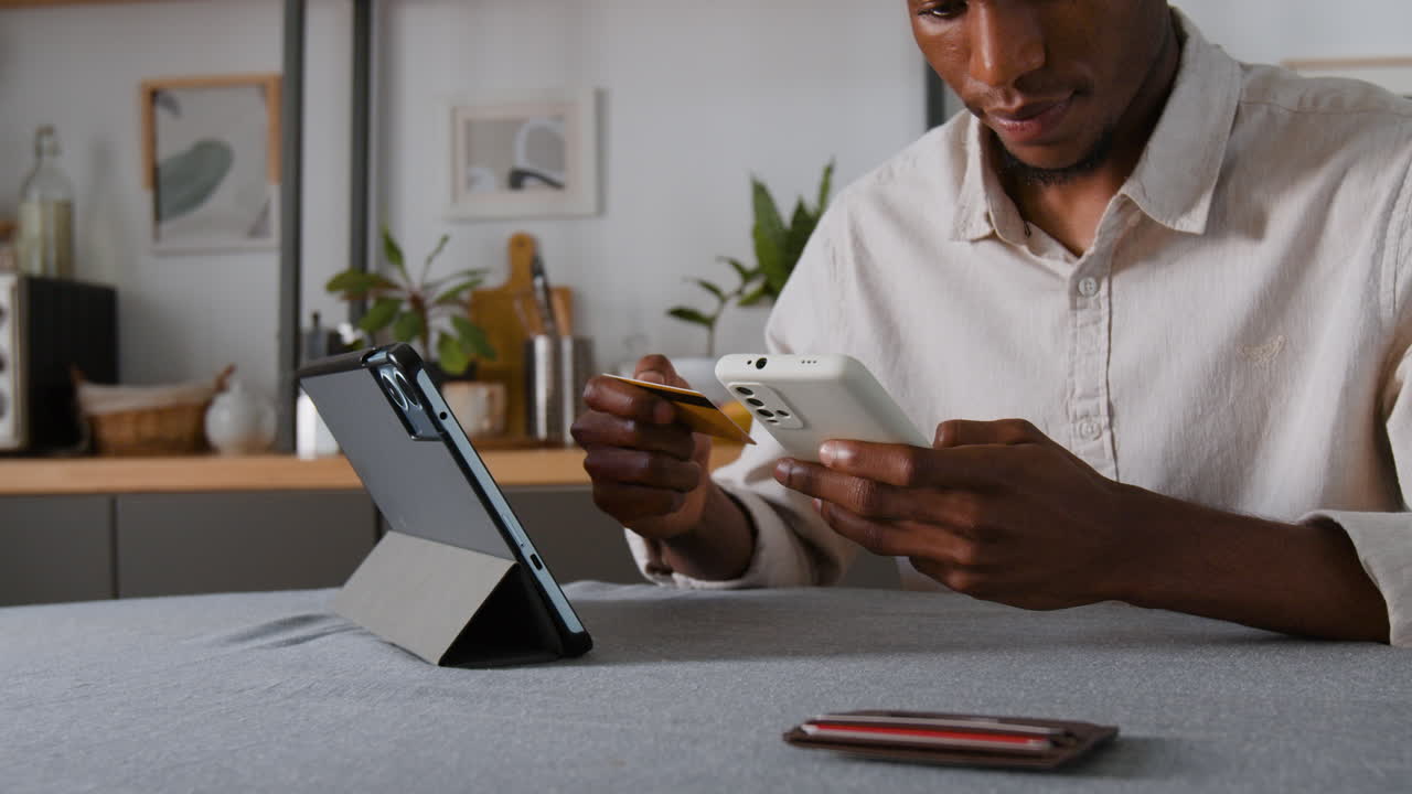 Man Using Tablet and Mobile Phone for Online Shopping