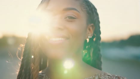 beautiful african american woman with braids smiling at the camera