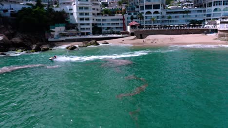 aerial tracking shot of riding jet ski from beach in mexico at day