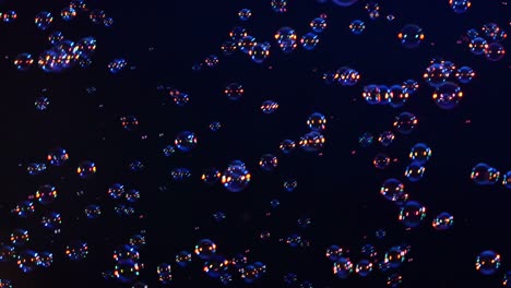 blue red and orange soap bubbles on black background a lot of blue red and orange soap bubbles isolated on black background