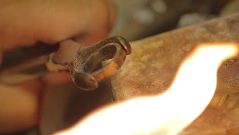 italian goldsmith at work building an engagement or a wedding ring