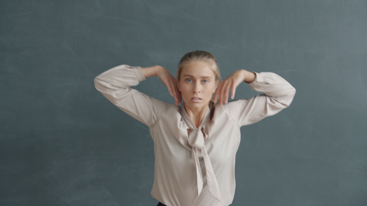 Woman Dancing in Front of a Chalkboard