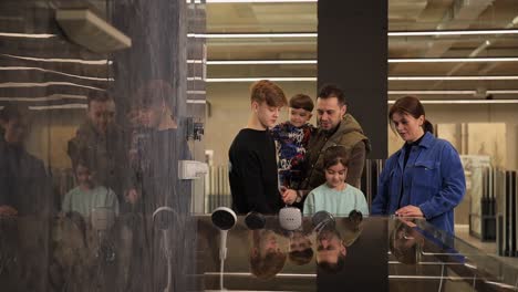family shopping for showerheads in a home improvement store
