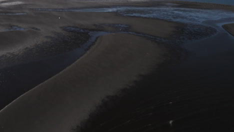 AERIAL---Approaching-coast,-Hvitserkur,Vatnsnes,-Iceland,-top-down-tilt-up-forward