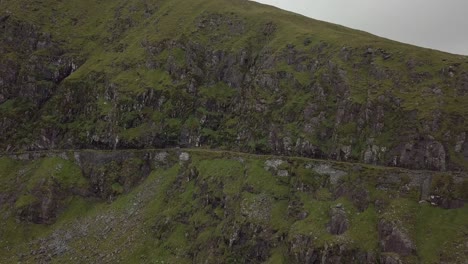 Aerial-footage-of-a-car-driving-on-mountain-roads