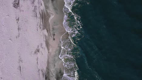 Flying-over-the-seaside,-over-the-beach,-and-the-Black-Sea-at-Vadu-natural-reservation,-in-the-Dobrogea-Region,-Romania