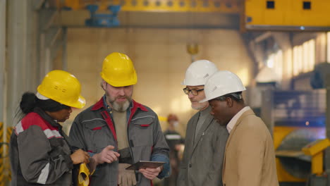 group of multiethnic engineers having discussion in factory