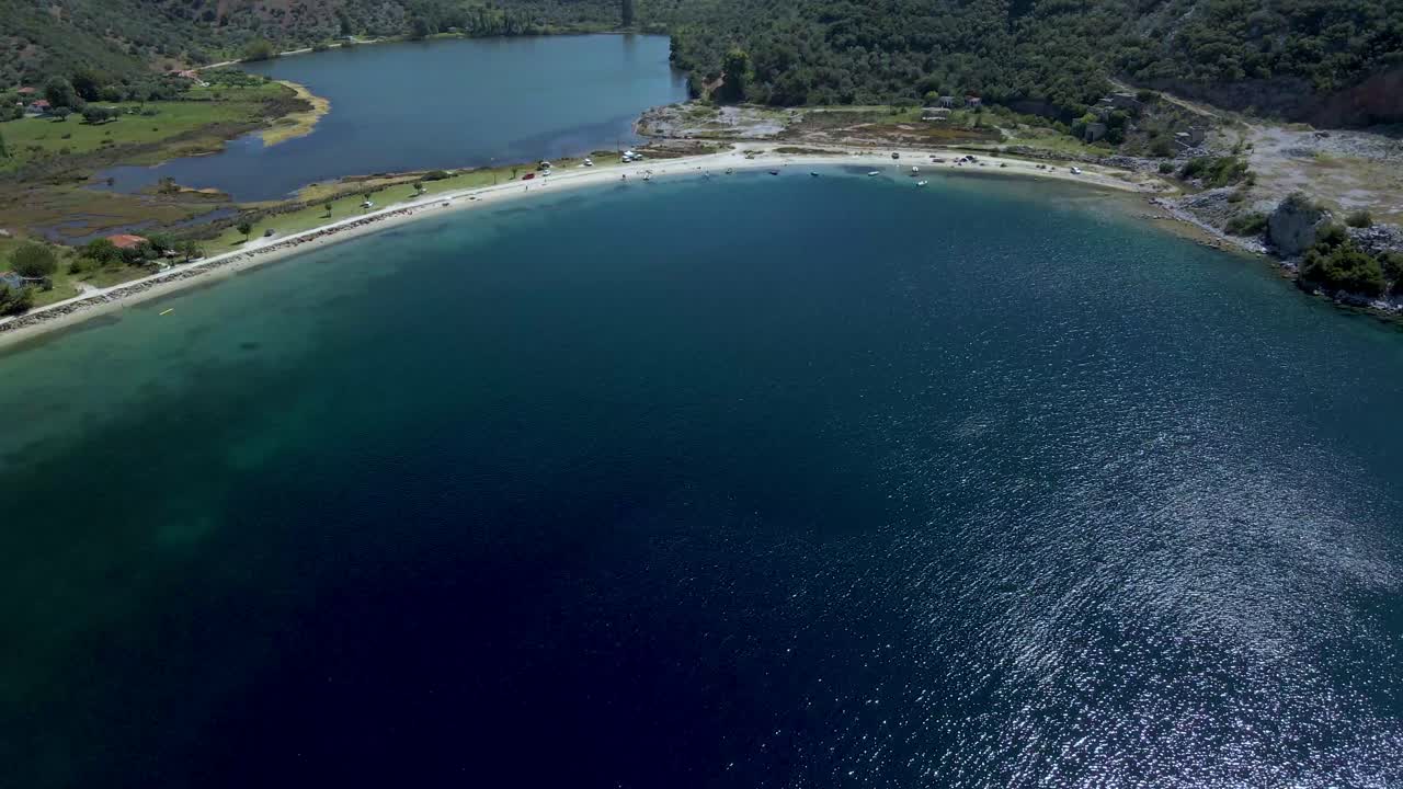 Cinematic forward moving 4K drone clip over the tropical blue waters of Toroni in Chalkidiki