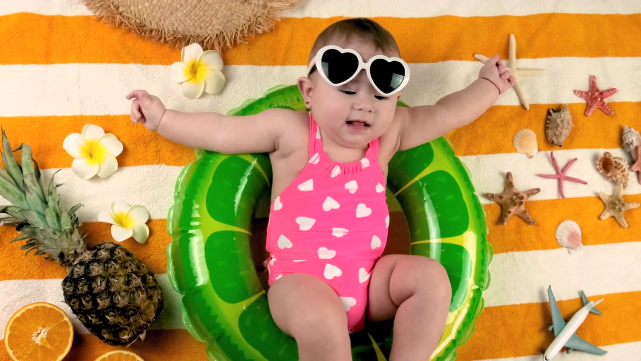 Little baby girl on the beach with a circle. Selective focus.