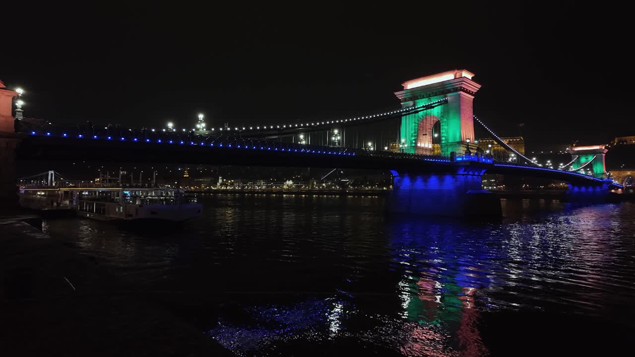 Night view of Szechenyi suspension bridge over Danube river, Budapest