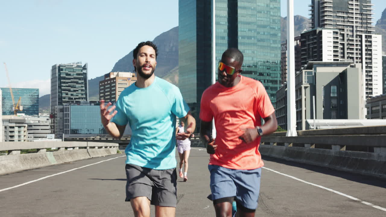 Two Men Jogging and Talking on a City Bridge on a Sunny Day