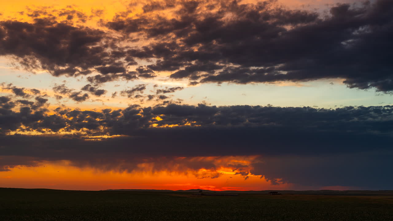 Colorful sunset clouds slowly drift in fading evening light