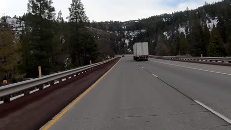 passing truck on highway and snowy landscape