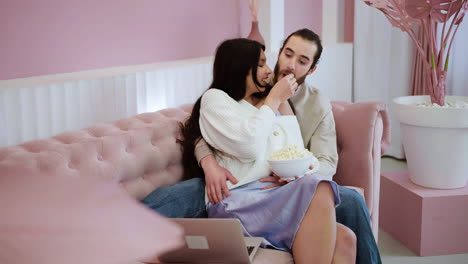 romantic couple eating popcorn