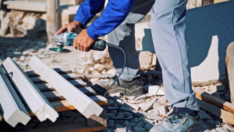 el trabajador pulida la piedra con un molinillo de mano al aire libre.