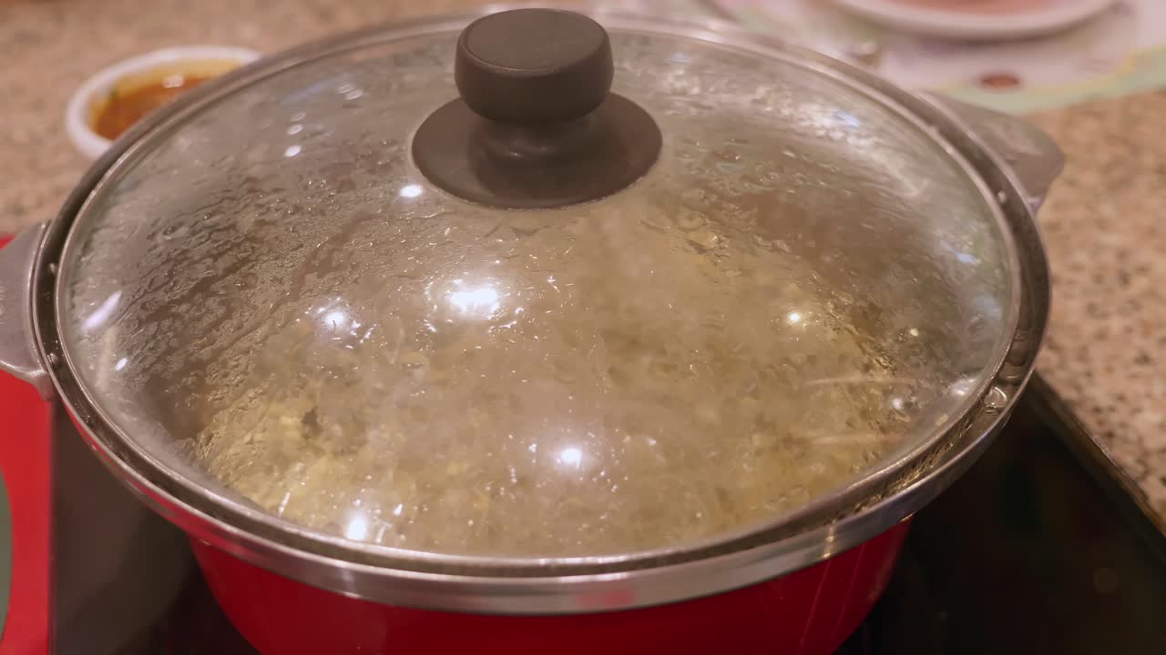 Detail of a pot boiling water on an induction stove