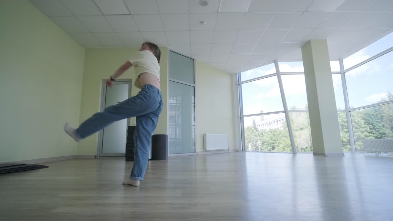 стильная молодая девушка танцует брейк-данс и хореографию.