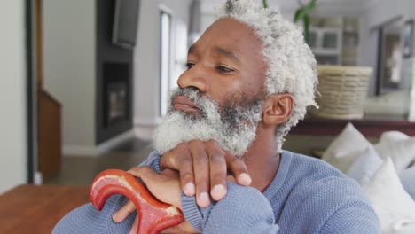 video of sad african american senior man with walking stick