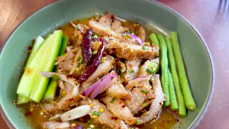 hand seasoning spicy pork salad with vegetables