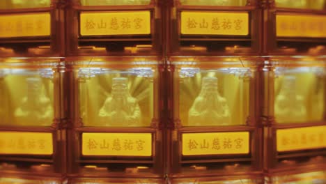 close-up of many golden buddha statues glowing in individual illuminated niches at ciyou temple in taiwan, symbolizing devotion, peace, and spiritual reverence in a sacred buddhist space